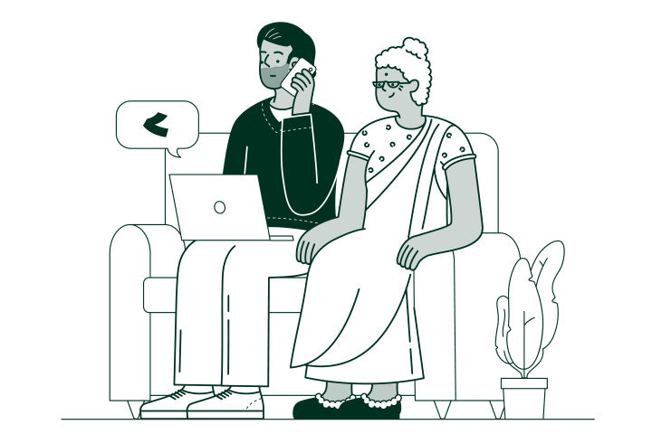 mother sitting on a sofa with her son who has a laptop on his knee and is on the phone