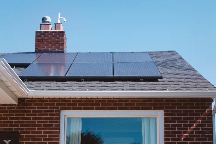solar photovoltaic panels mounted on a tiled house roof